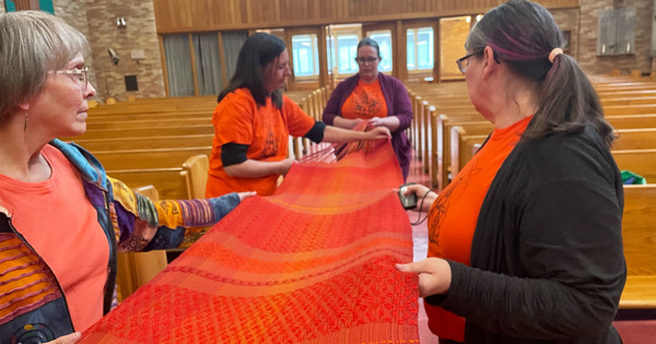 Remembering the Children Weaving Dedicated During Prayer Service