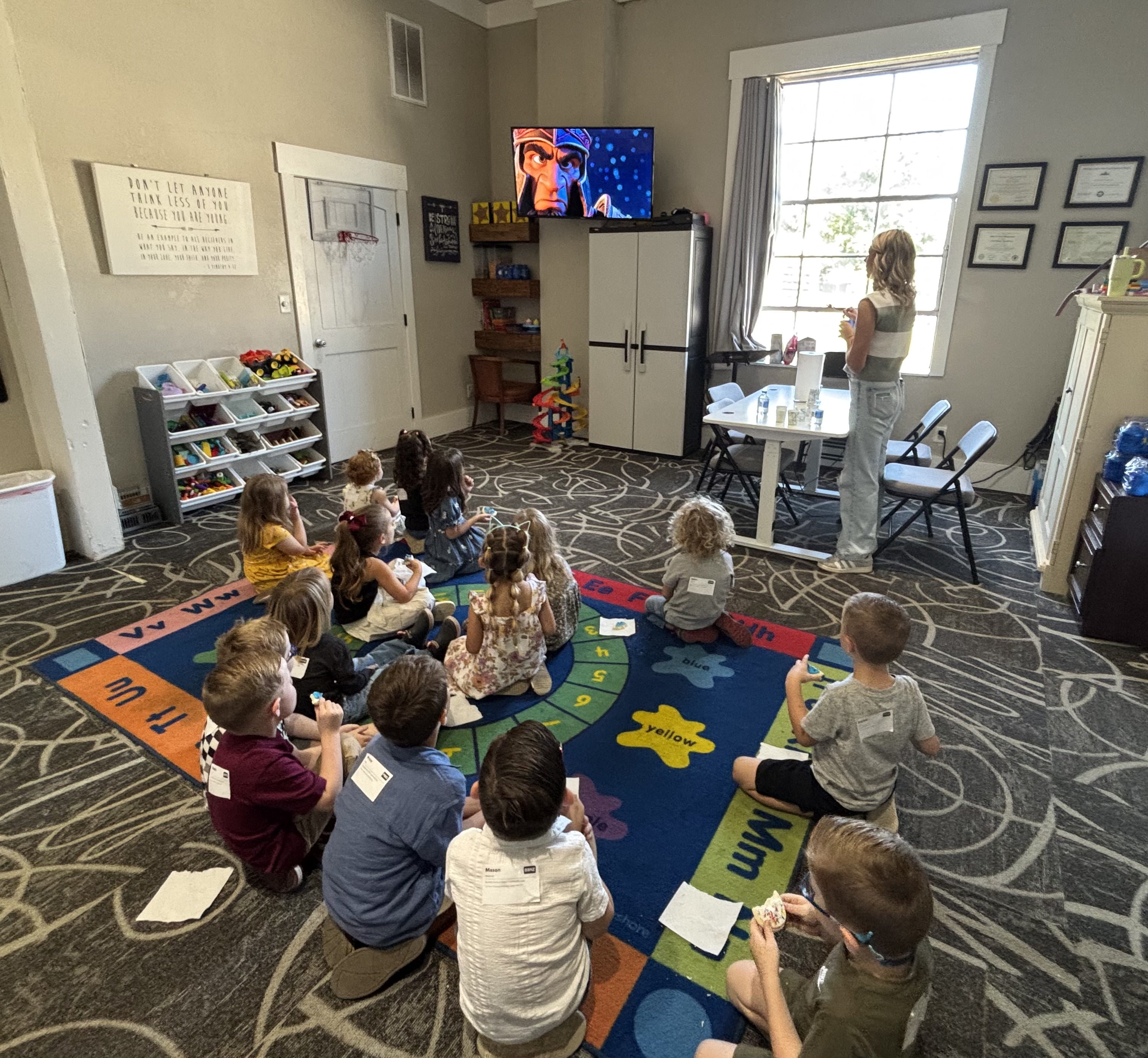 The Bigs class sitting on the rug watching the lesson